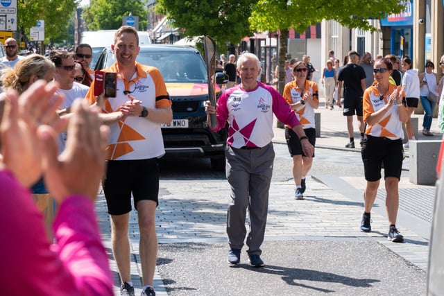 Peter Warden holds the baton aloft