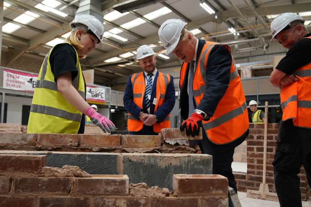 Prime Minister Boris Johnson takes part in a brick laying lesson at Blackpool and The Fylde College