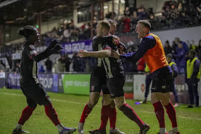 Mark Ellis, second from right, is congratulated after his deflected effort makes it 4-2 against Southport (photo: David Airey/dia_images)