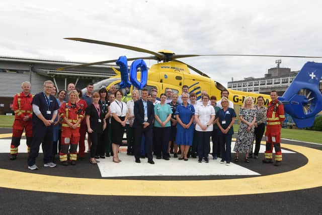 Staff and emergency services gather to mark the 10th anniversary of the Major Trauma Centre at the Royal Preston Hospital on the helipad via which many of the unit's patients arrive