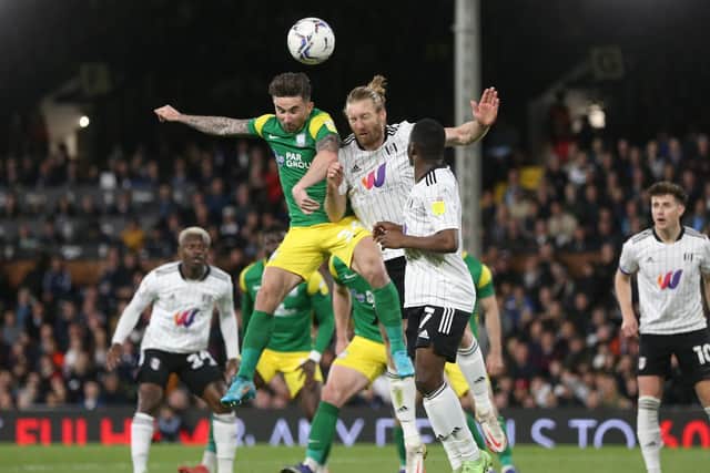Preston North End striker Sean Maguire challenges in the air with Fulham skipper Tim Ream