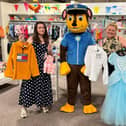 Paw Patrol's 'Chase' helps the Sue Ryder Blackburn staff get ready for the shop's summer sale day