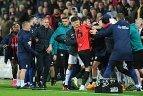 Ryan Lowe is pulled away while tempers flare at the end of PNE's defeat against Swansea