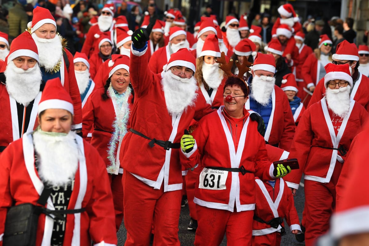 Merry scenes as dozens of dancing Santas and their dogs dash through Garstang