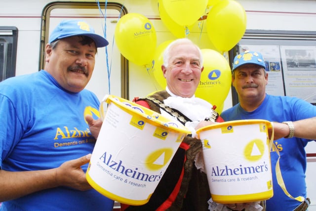Mayor helping volunteers wth Alzheimers dementia care and research collection.