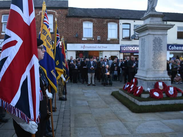 Standing to attention at the war memorial