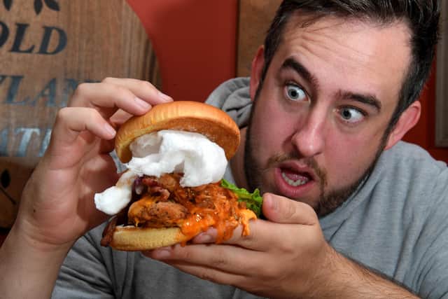 Paul O'Connor tries the chicken burger topped with candy floss, at The Old Leyland Gates, part of the Flaming Grill pub chain.