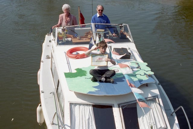 People wandering along North West canal towpaths may be surprised to spot a giant jigsaw piece pass by. The huge piece is being transported by canal to the World Canals Conference in Birmingham. Philip White of St Thomas' Primary School, Garstang, winner of an Inland Waterways drawing competition can be seen aboard a canal boat carrying the jigsaw piece