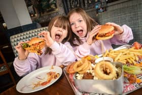 New funfair themed burger at the Lord Derby Flaming Grill in St Annes.  Pictured are sisters Adriana Sutton, 7 and Autumn Sutton, 8.