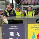 Cllr Freddie Bailey (right), with Ellie Tebbott,  Preston City Council's waste technical officer, and a street cleaning crew with one of the new recycling bins near Market Hall