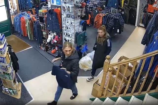Officers still need to identify the woman who is carrying a t-shirt in this CCTV image (Credit: Lancashire Police)