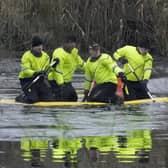 SOLIHULL, ENGLAND - DECEMBER 12: Emergency workers continue the search for further victims after a number of children fell through ice on a lake,  on December 12, 2022 at Babbs Mill Park in Solihull, England. Three boys aged eight, 10 and 11 have died after falling through an icy lake here last night. The search continued for more potential victims, following reports more children were present on the ice at the time of the incident. (Photo by Christopher Furlong/Getty Images)