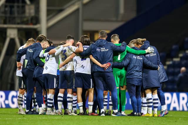 Preston North End players huddle after the match