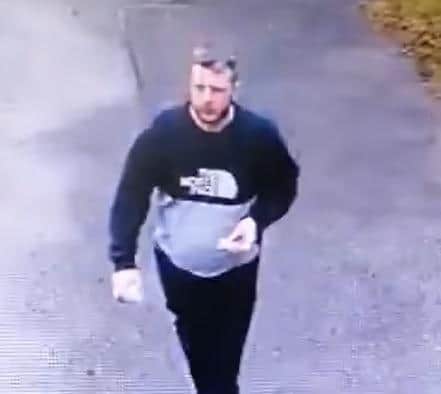 This man was captured on CCTV and is later seen kicking his way into the church building