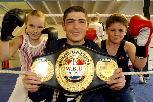 Michael Jennings, the new WBU champion, meets Natasha Bell, 12, and Thomas Monks, 10, during his visit to Leyland Amateur Boxing Club on Dunkirk Lane, Leyland