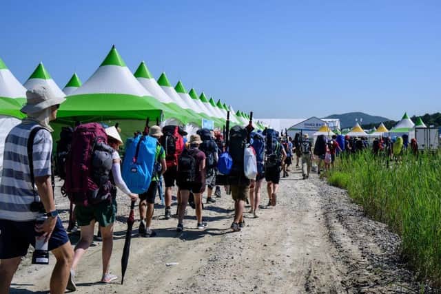 Scouts prepare to leave the World Scout Jamboree in Buan, North Jeolla province (Photo by ANTHONY WALLACE/AFP via Getty Images)