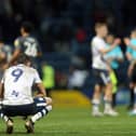 Preston North End's Ched Evans dejectedly sits on his haunches at the final whistle