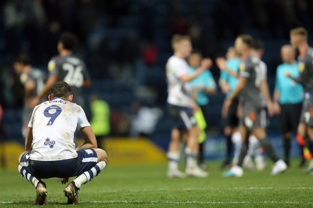 Preston North End's Ched Evans dejectedly sits on his haunches at the final whistle