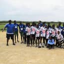Pupils at Ufuoni Primary School wear football shorts, shirts and half zips donated to them by Leyland Pirates F.C.