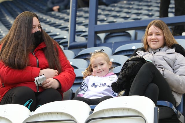 Three PNE fans wait for the game to start at Deepdale