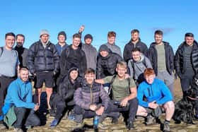 Twins Jacob (front row third from left) and Josh Thornton (fourth from left) with some of the friends who climbed Pendle Hill with them. The brothers are preparing to tackle the National Three Peaks Challenge to raise money for the mental health charity MIND