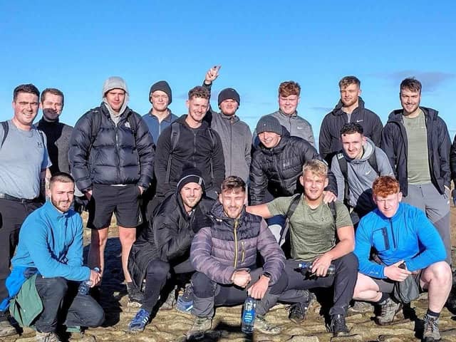 Twins Jacob (front row third from left) and Josh Thornton (fourth from left) with some of the friends who climbed Pendle Hill with them. The brothers are preparing to tackle the National Three Peaks Challenge to raise money for the mental health charity MIND