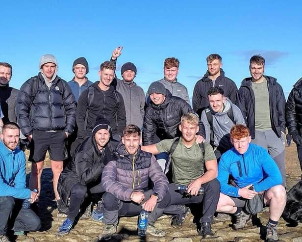 Twins Jacob (front row third from left) and Josh Thornton (fourth from left) with some of the friends who climbed Pendle Hill with them. The brothers are preparing to tackle the National Three Peaks Challenge to raise money for the mental health charity MIND
