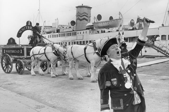 In preparation for the opening of the Manxman floating entertainments complex an extra special delivery of beer was made. A convoy of Whitbread vehicles arrived pulled by Shire horses and complete with dray carts. Pictured: Town Crier Edwin Bowkett of Lytham heralds the arrival of Whitbread Brewery wagons led by Shire horses Jupiter, Saturn, Pikeman and Muskateer