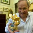Owner of GB Antiques Allan Blackburn with some Pendelfin figures.