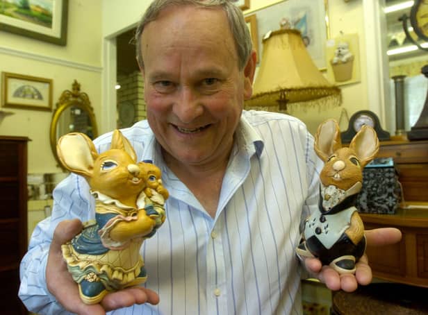 Owner of GB Antiques Allan Blackburn with some Pendelfin figures.