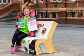 Lara Pritchard (10) on the book bench trail in Chorley as part of the What's Your Story Chorley festival