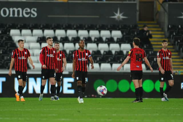 Preston North End players look dejected after Swansea's third goal