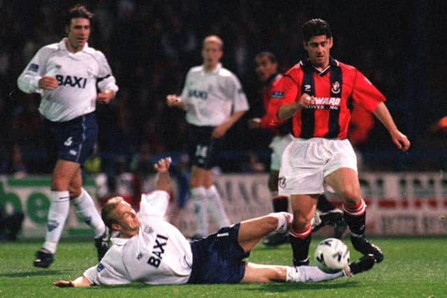 Preston North End winger Lee Cartwright slides in to tackle Bournemouth midfielder Steve Robinson