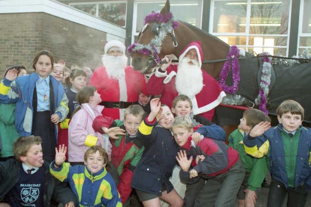 Youngsters from a Lancashire village school were given a double festive delight when Santa Claus arrived with a police escort. Santa and his lookalike helper stepped into Newton Bluecoat School, Newton, near Kirkham, on a horse drawn sleigh with police horse Viscount giving Rudolph a break from the reins