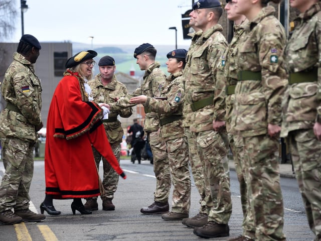 Councillor Julia Berry greets some of the regiment