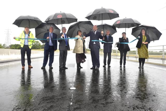 Driving on through the rain at the ribbon-cutting ceremony