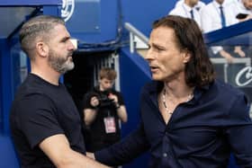 Preston North End's manager Ryan Lowe (left) is greeted by Queens Park Rangers' manager Gareth Ainsworth