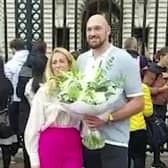 Video grab of Tyson Fury laying flowers down outside Buckingham Palace