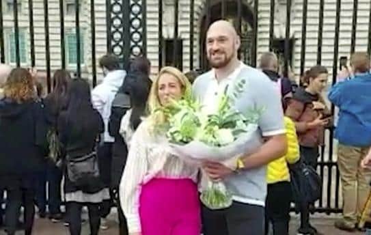 Video grab of Tyson Fury laying flowers down outside Buckingham Palace