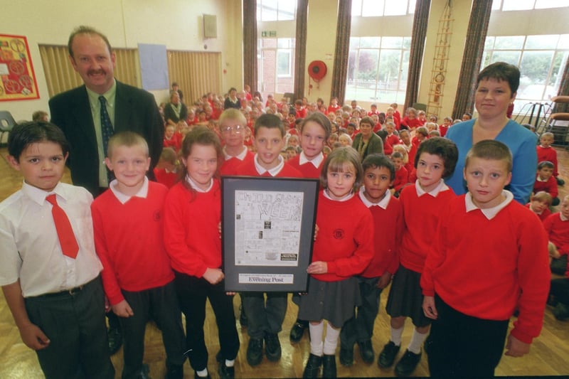 English Martyrs RC Primary School headteacher Adrian Dunn and pupils receive their Child Safety Week poster from Jane Martin from the Lancashire Evening Post