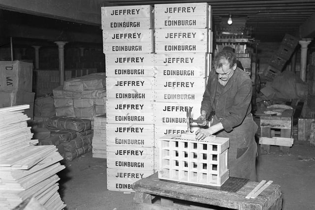 A worker at the Heriot Brewery, on Roseburn Terrace, making cases to put beer bottles in December 1955.
