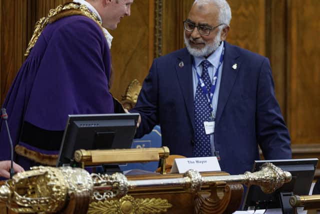 Neil Darby - thought to be Preston's youngest mayor at 34 - is welcomed to his new role by departing mayor Javed Iqbal (image: Michael Porter Photography)