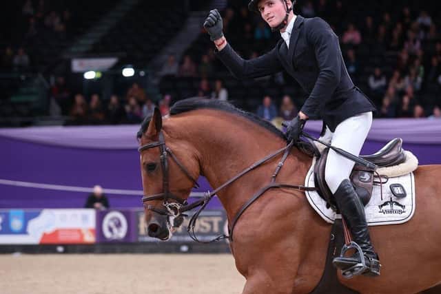 Robert Murphy takes the applause from the crowd after going clear at the Horse of the Year Show