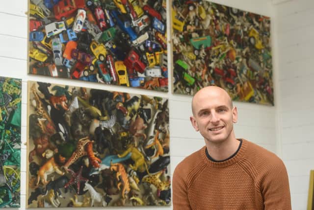 Artist Gary Armer has won the British Art Prize 2022 with one of his paintings. Here he is shown with other works in the series