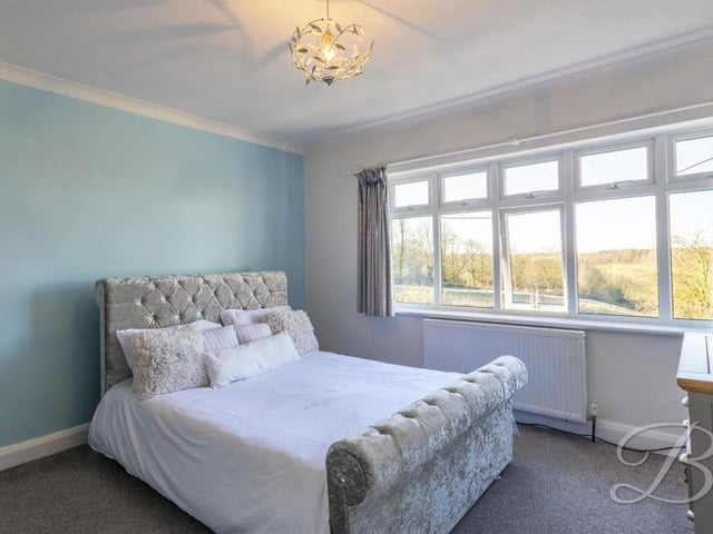 Completing our tour of the bedrooms is this elegant one that provides views of the High Oakham Hill property's extensive garden.