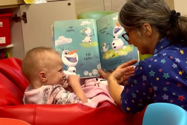 Freya Duckworth, pictured in hospital during her treatment, with play specialist Anya.