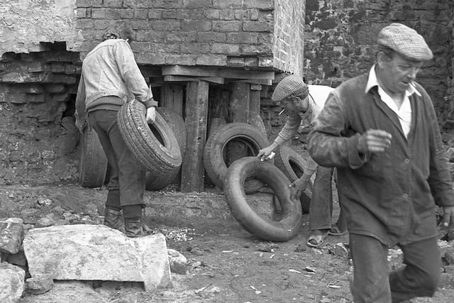 Fred Dibnah (front right) with men shoring up the chimney in the background. Picture courtesy of Keith Taylor.