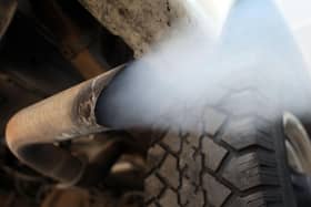 Exhaust flows out of the tailpipe of a vehicle at , "Mufflers 4 Less", July 11, 2007 in Miami, Florida. Florida Governor Charlie Crist plans on adopting California's tough car-pollution standards for reducing greenhouse gases under executive orders he plans to sign Friday in Miami.  (Photo by Joe Raedle/Getty Images)