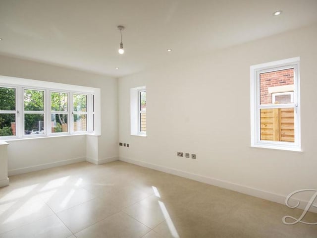 A second shot of the living room or snug, showing its attractive bay front window.