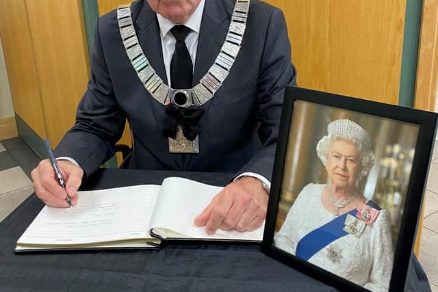Ribble Valley Mayor Stuart Hirst signs a book of condolence at the Ribble Valley Borough Council Offices.